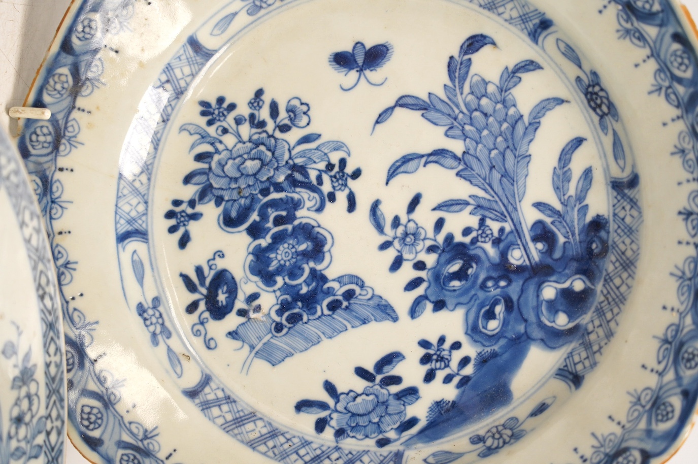 Four Chinese blue and white export plates and a rice bowl, bowl 24.5cm diameter. Condition - poor to fair, some damage to the edges